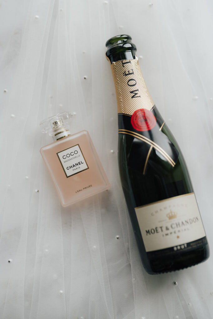 Champagne bottle and perfume on the veil