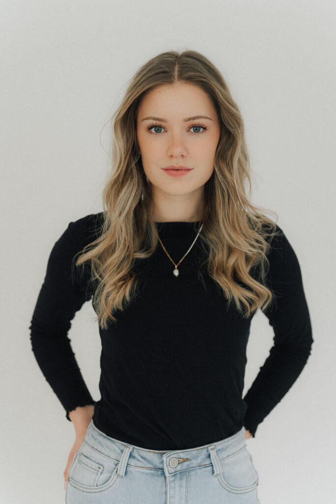 Timeless portrait of woman in black top, showcasing natural elegance and soft aesthetics